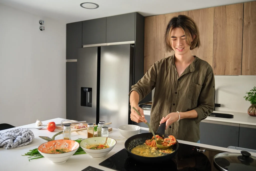 Person preparing homemade Massaman curry