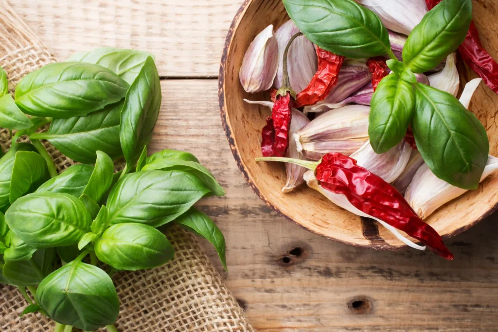 Fresh holy basil leaves and red peppers with garlic