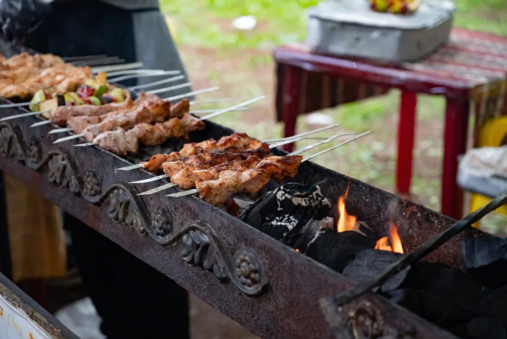 Chicken satay skewers grilling over charcoal for authentic smoky flavor