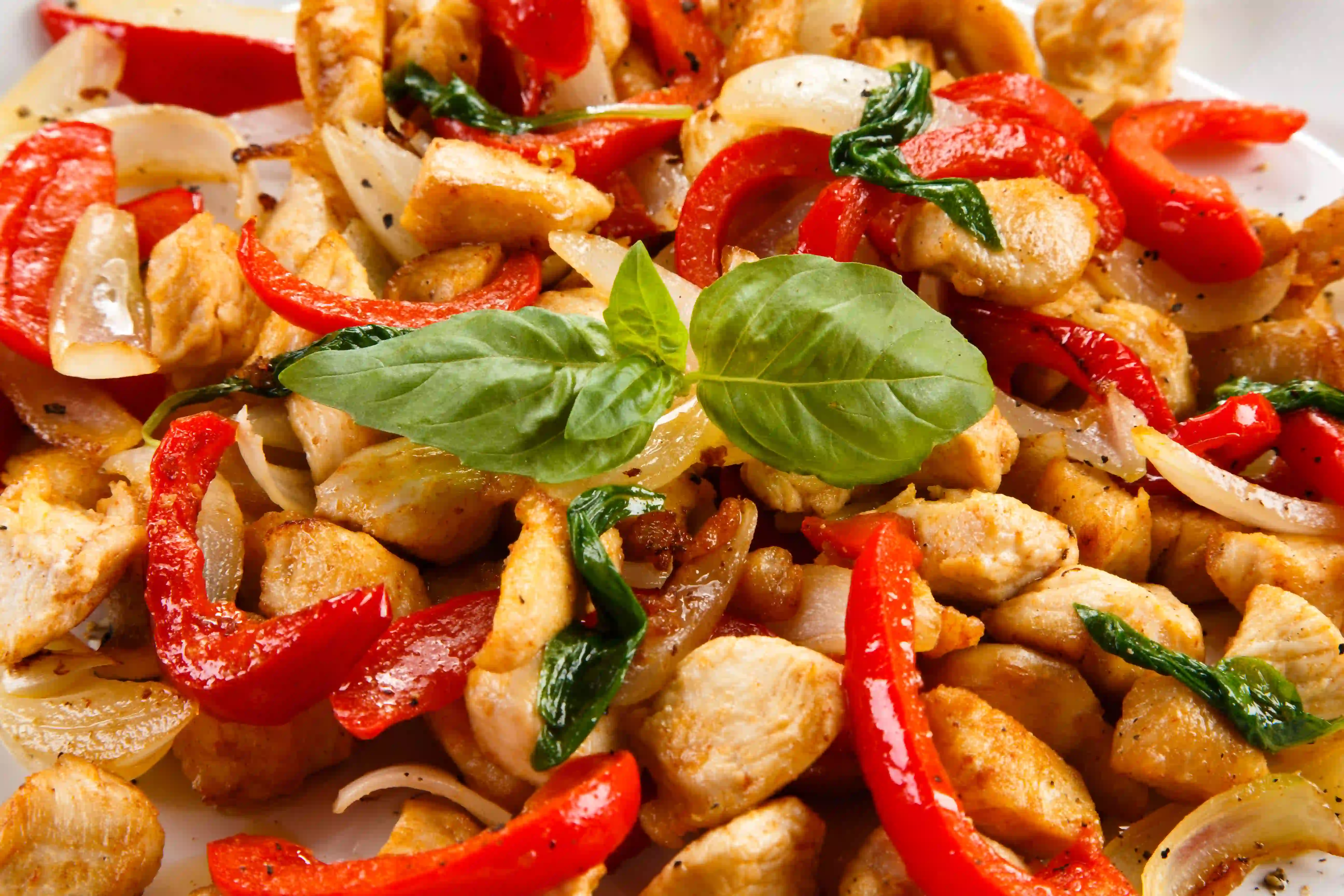 Traditional Thai Basil Chicken with fresh basil and chili peppers